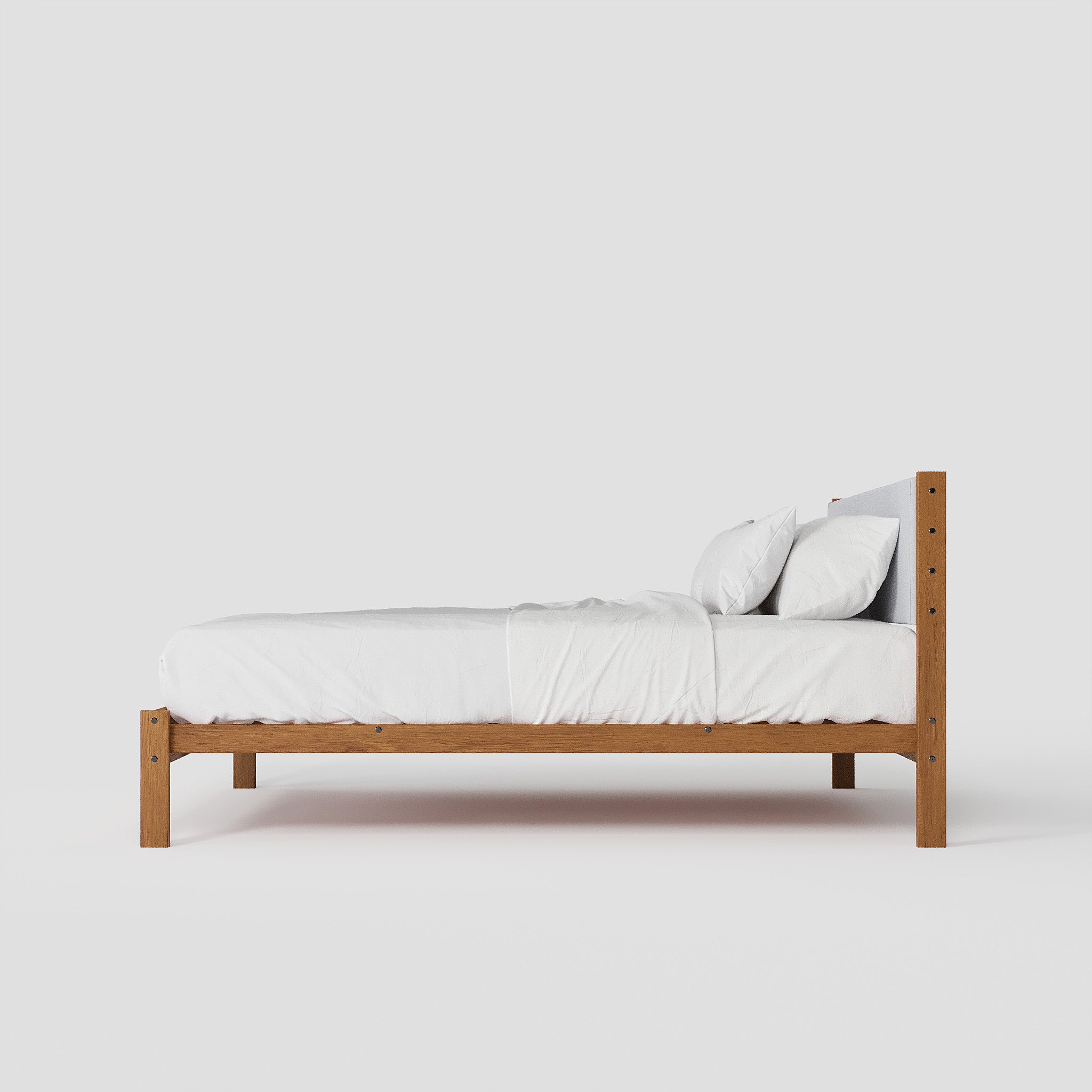 Wooden bed frame with white bedding on a plain background